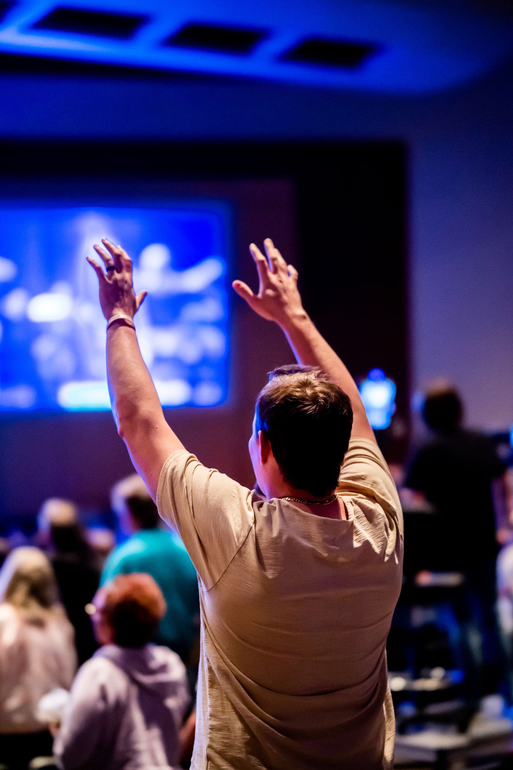 A man raising his hands in worship