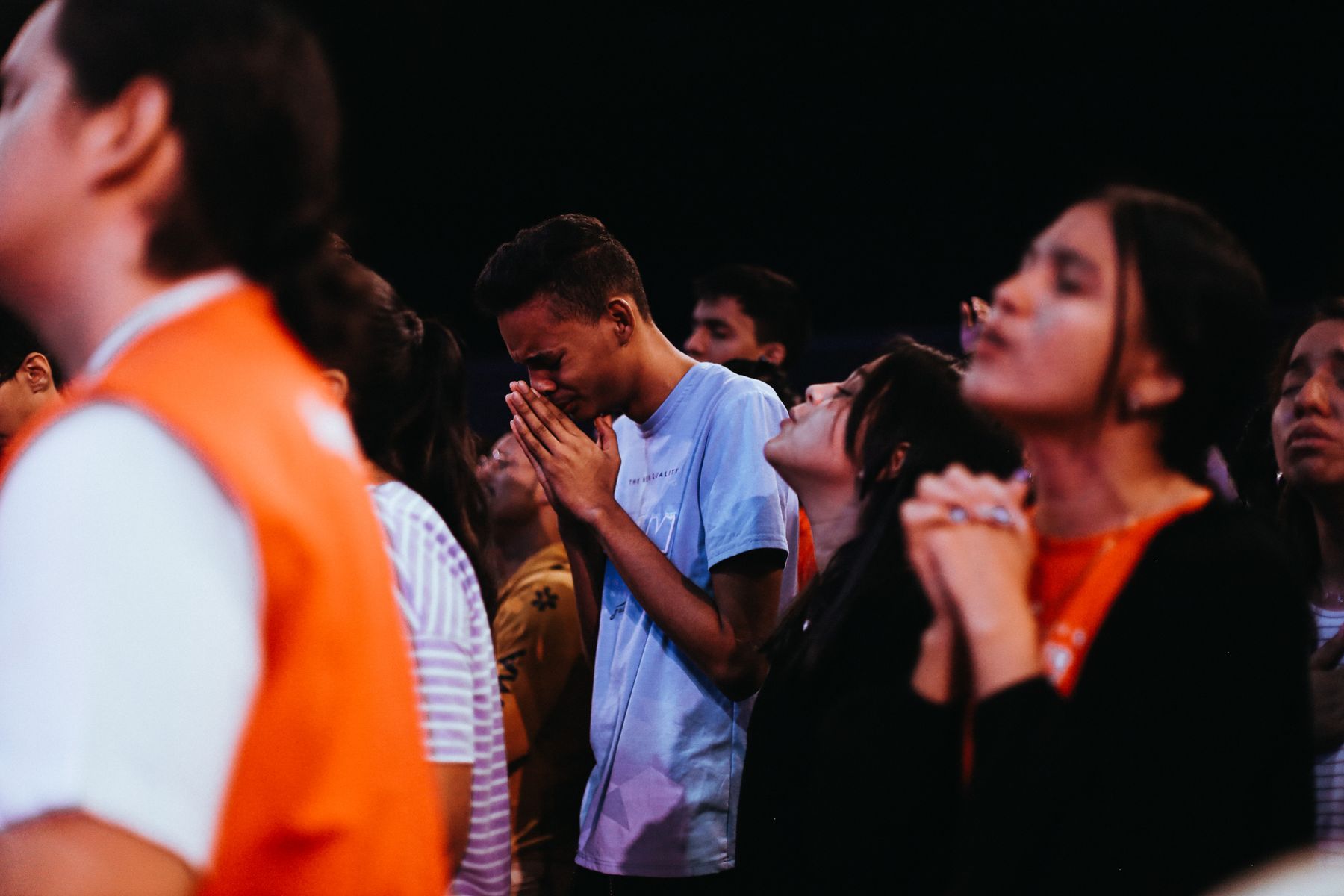 Young adults praying together